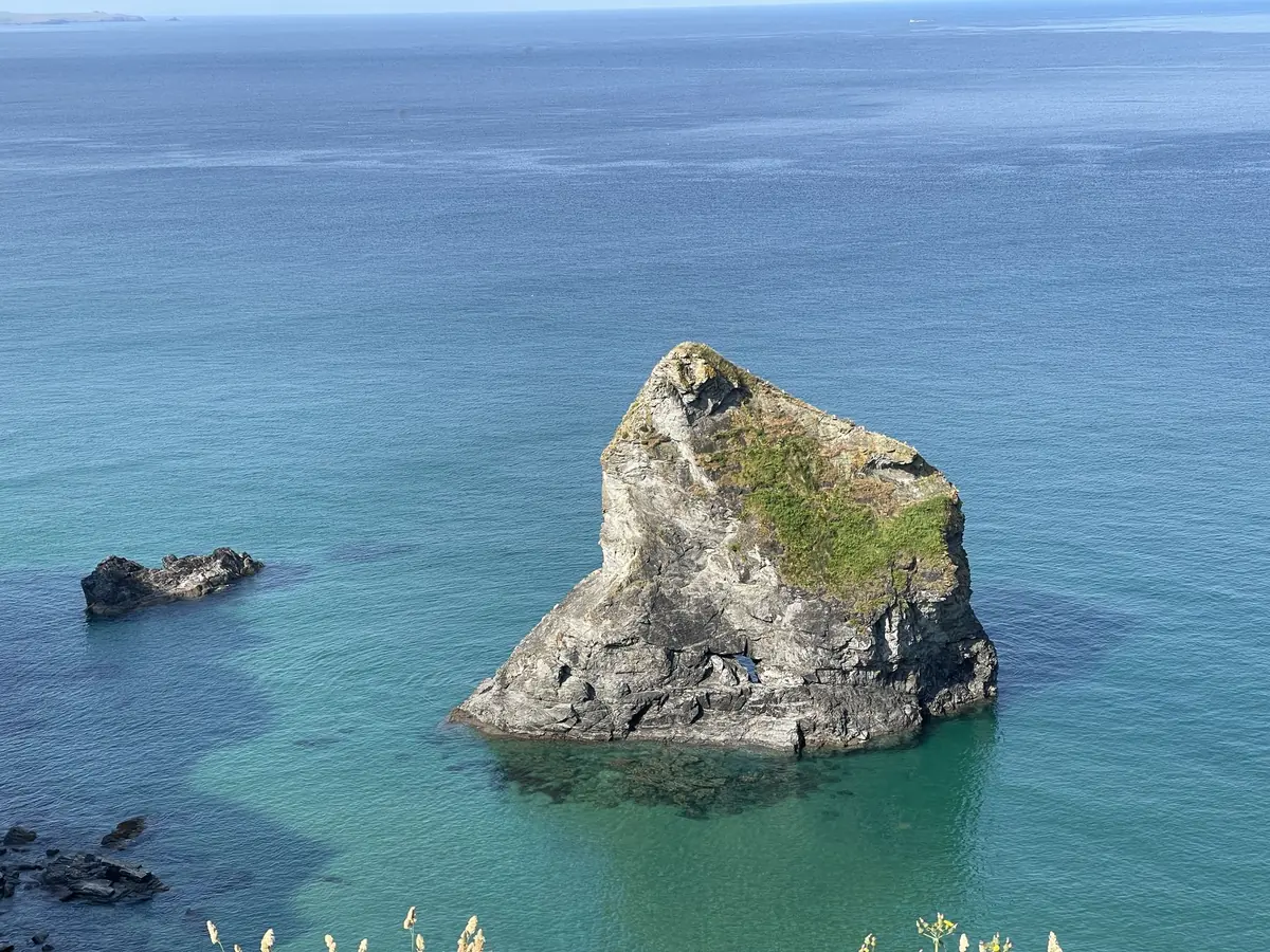 A lone rock stack in clear turquoise water