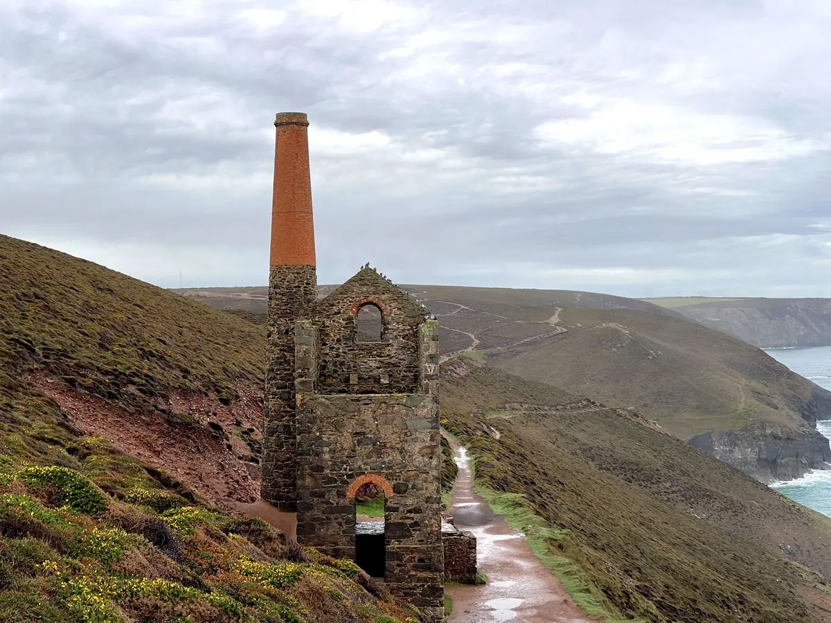 An engine house beside a coast path above the sea